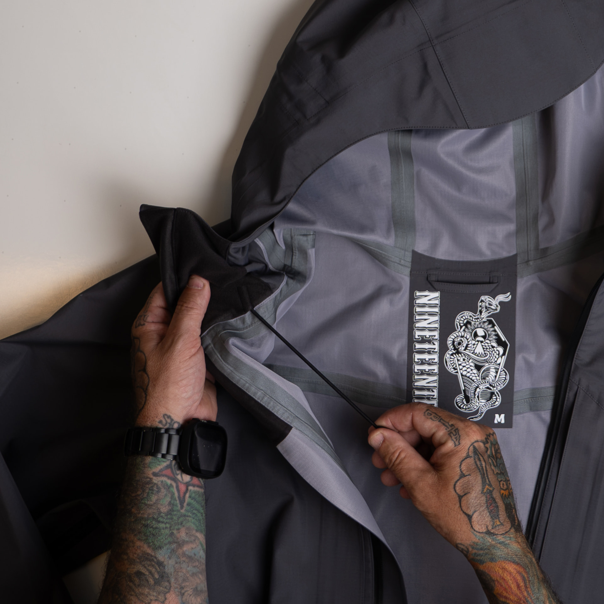 Hood and waist cinch cords with Nineteenten label